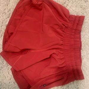 Lululemon tracker shorts. Size 4. Redish orange color